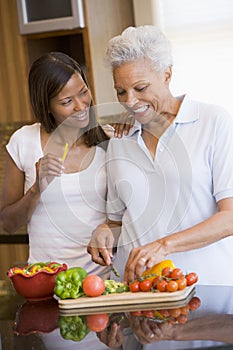 Mother And Daughter Preparing A Meal