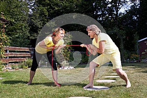 Mother and daughter pulling rope