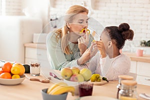 Mother and daughter putting pepper to face pretending it to be moustache