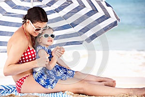 Mother And Daughter Putting On Sun Cream