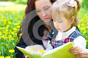 Mother with daughter read a book