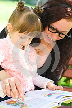 Mother with daughter read a book