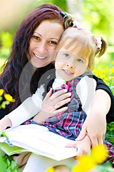 Mother with daughter read a book