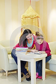 Mother and daughter read book