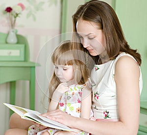 Mother with the daughter read the book