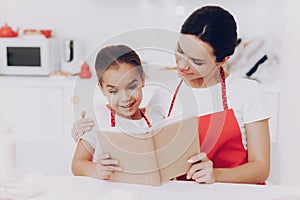 Mother and Daughter Read Book. Cake for Family.