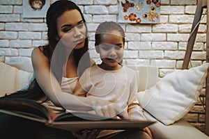 Mother with Daughter is Reading a Book