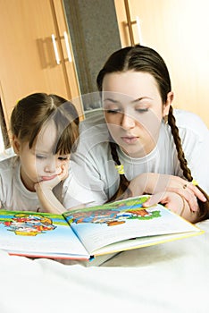 Mother and daughter reading a book