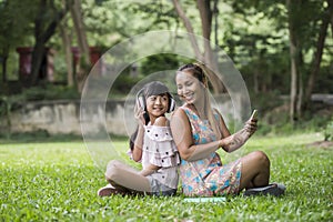 Mother and daughter reading a fairytale to her daughter listen sound with headphone