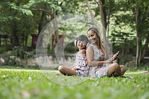 Mother and daughter reading a fairytale to her daughter listen sound with headphone