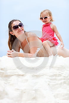 Mother and daughter relaxing at beach