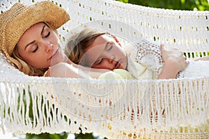 Mother And Daughter Relaxing In Beach Hammock