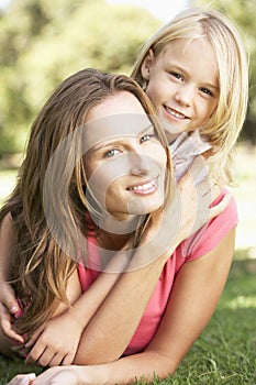 Mother And Daughter Relaxing Together In Park