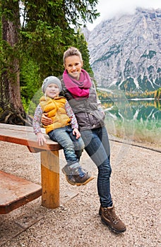 Mother and daughter resting at wooden picnic table on Lake Bries photo