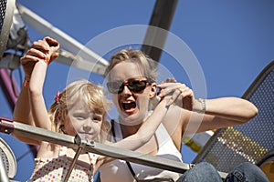 Mother and Daughter on a Ride at the Amusement Park