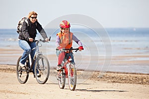 Mother and daughter riding on bicycles