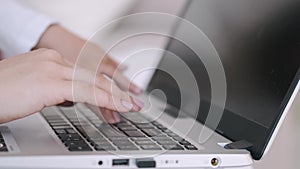 Mother and daughter's hands typing on the laptop keyboard