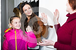 Mother with daughter saying goodbye to grandmother