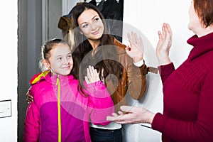 Mother with daughter saying goodbye to grandmother