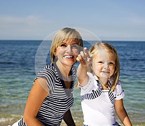 Mother with daughter at sea cost together, happy real family smiling looking to horizont, lifestyle people concept, on