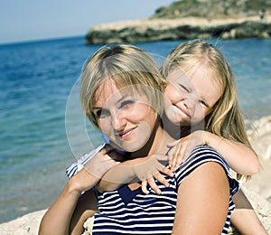 Mother with daughter at sea cost together, happy real family smiling looking to horizont, lifestyle people concept, on