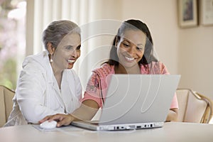 Mother and daughter sharing computer