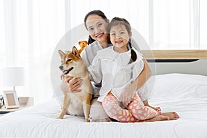 Mother and daughter with Shiba Inu.