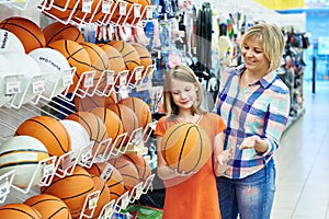Mother and daughter shopping basketball ball