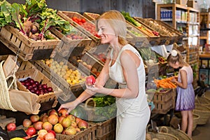 Mother with daughter shopping fruits