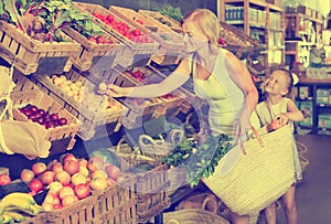 Mother with daughter shopping fruits