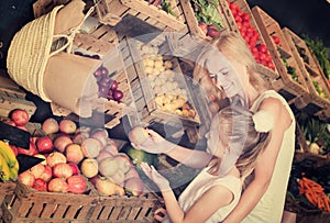 Mother with daughter shopping fruits