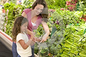 Mother and daughter shopping for produce