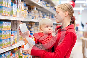 Mother with daughter shopping in supermarket