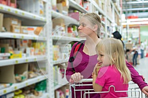 Mother and daughter shopping in supermarket