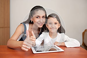 Mother and daughter showing thumb