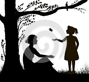 Mother and daughter silhouette, young woman is sitting under the tree and girl is trying to catch butterfly, family