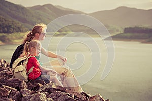 Mother and daughter sitting on the beach