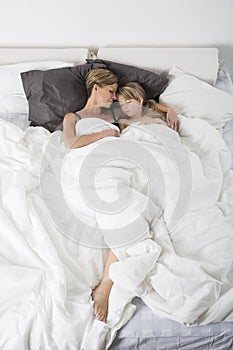 Mother and daughter sleeping from high angle view