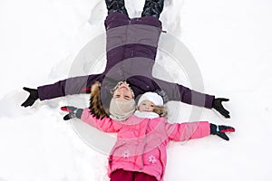 Mother and daughter on the snow