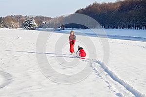 Mother and daughter in snowy winter park