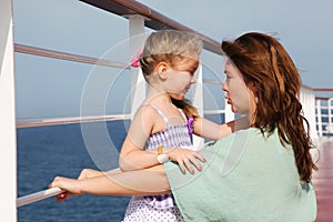 Mother and daughter speaking on cruise liner deck