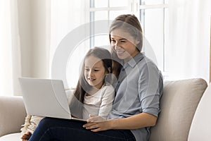 Mother and daughter spend weekend leisure on internet use laptop