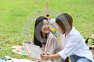 Mother and daughter spending leisure time together at park.