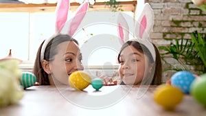 Mother and daughter stealing searching Easter eggs