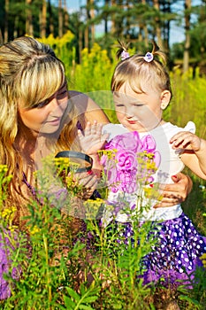 Mother and daughter are studying the nature