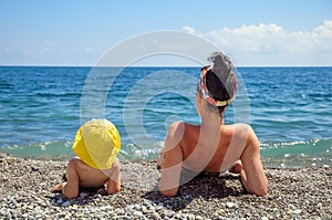 Mother and daughter sunbathe on the beach