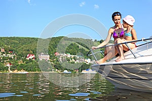 Mother daughter sunbathing and talking on cutter