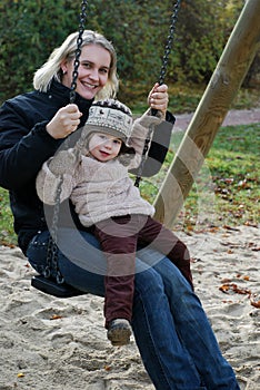 Mother and daughter swinging