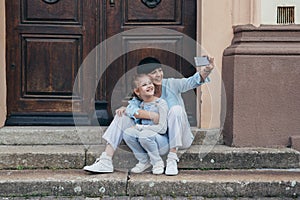 Mother and daughter taking selfie with cellphone