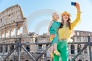 Mother and daughter taking a selfie at the Colosseum in Rome